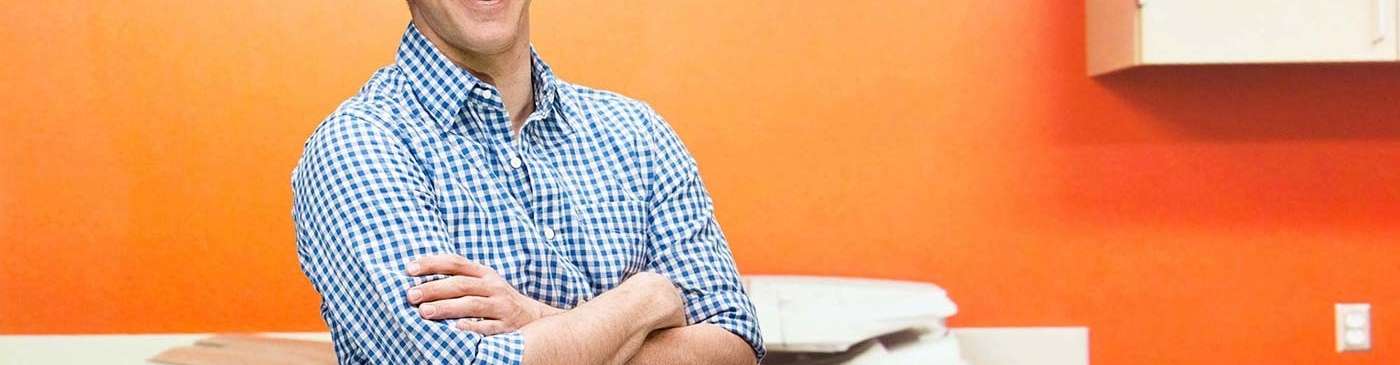 Smiling man by copier